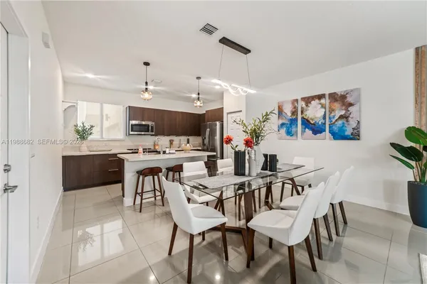 a view of a dining room with furniture and chandelier