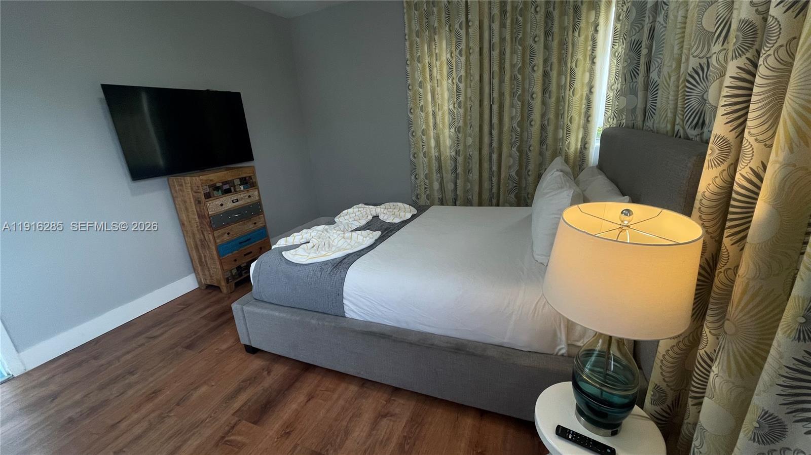 8100 Harding Avenue, Unit 508 Miami Beach, FL 33141 - Photo 14 of 20 a bed sitting in a bedroom next to a window