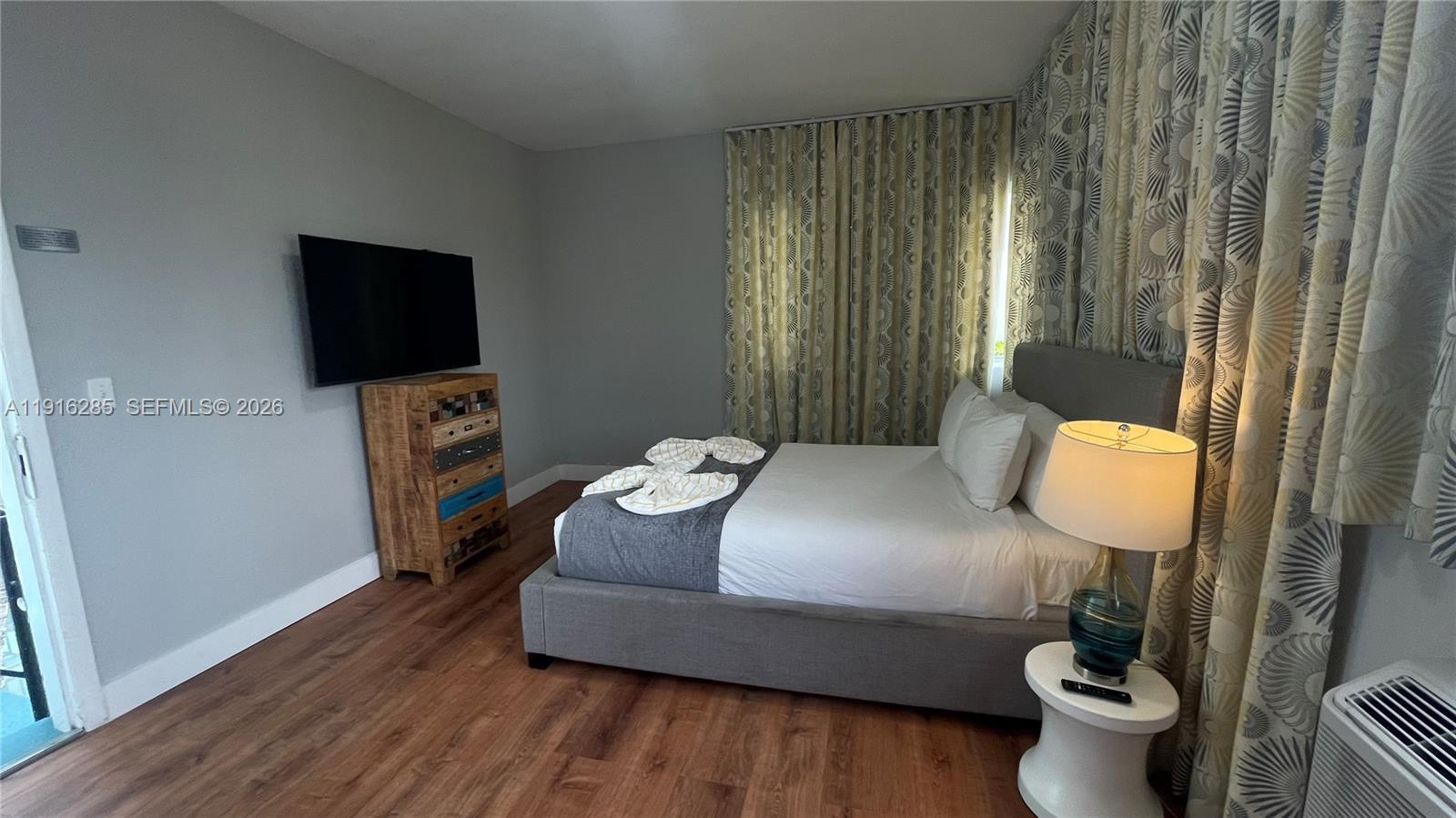 8100 Harding Avenue, Unit 508 Miami Beach, FL 33141 - Photo 18 of 20 a bedroom with a bed and window