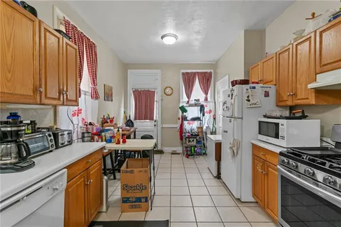 a kitchen with a sink appliances and cabinets