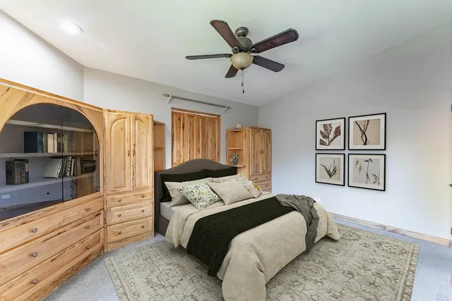 a bathroom with a granite countertop toilet a mirror and a shower