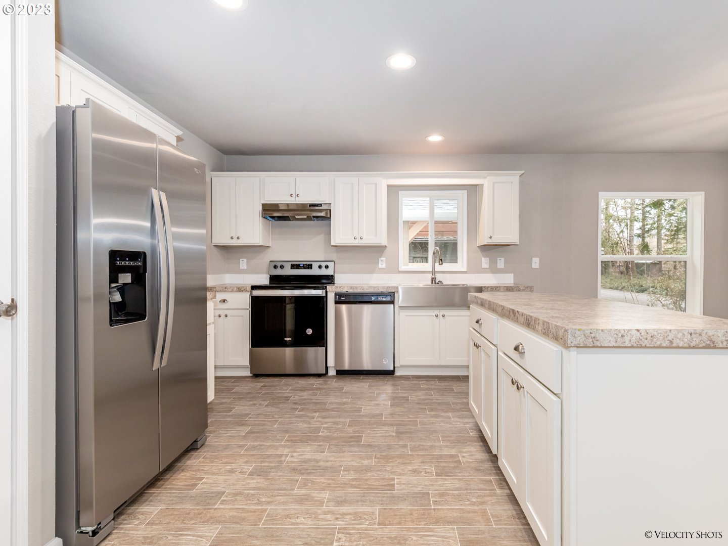 65195 East Sandy River Lane Rhododendron, OR 97049 - Photo 11 of 29 a kitchen with stainless steel appliances granite countertop a refrigerator and a sink
