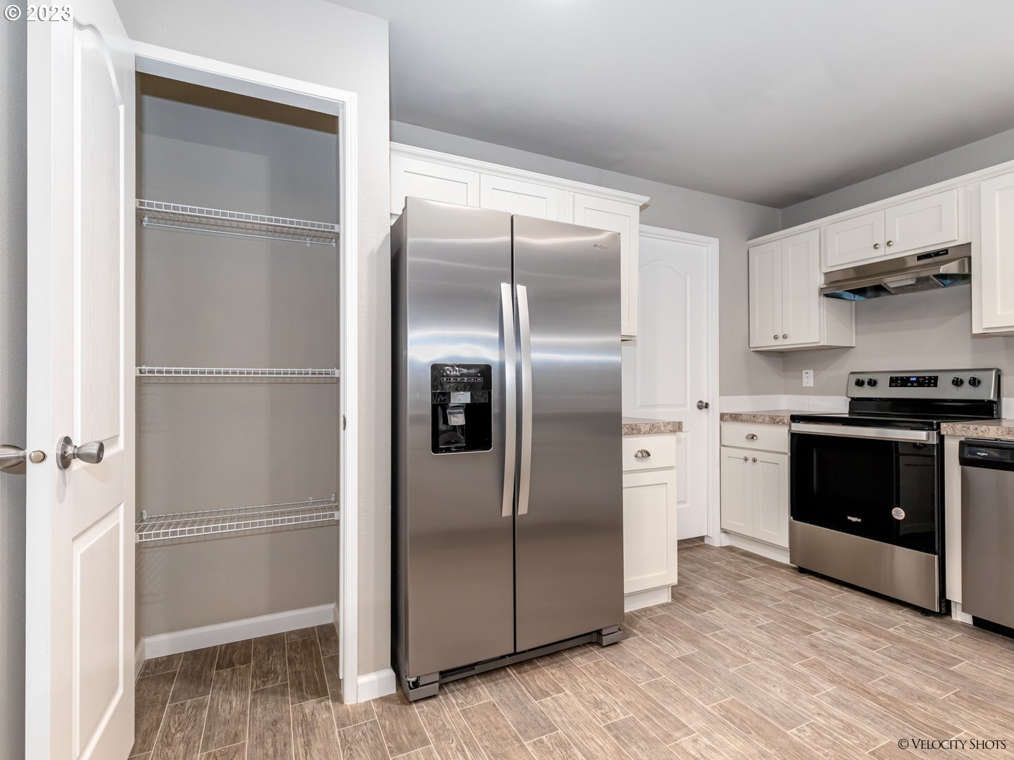 65195 East Sandy River Lane Rhododendron, OR 97049 - Photo 12 of 29 a kitchen with a refrigerator and a stove top oven