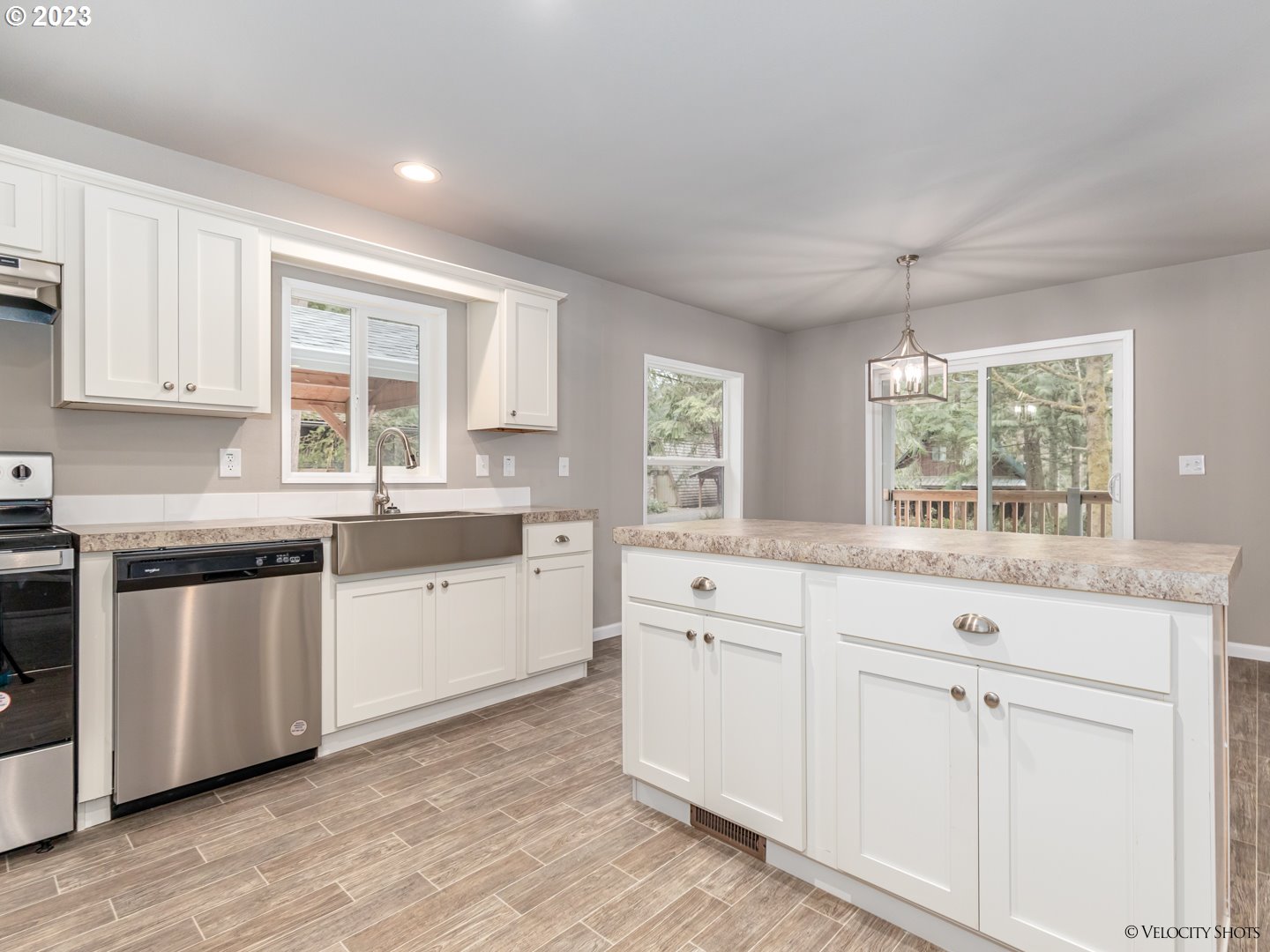 65195 East Sandy River Lane Rhododendron, OR 97049 - Photo 13 of 29 a kitchen with granite countertop white cabinets and a window