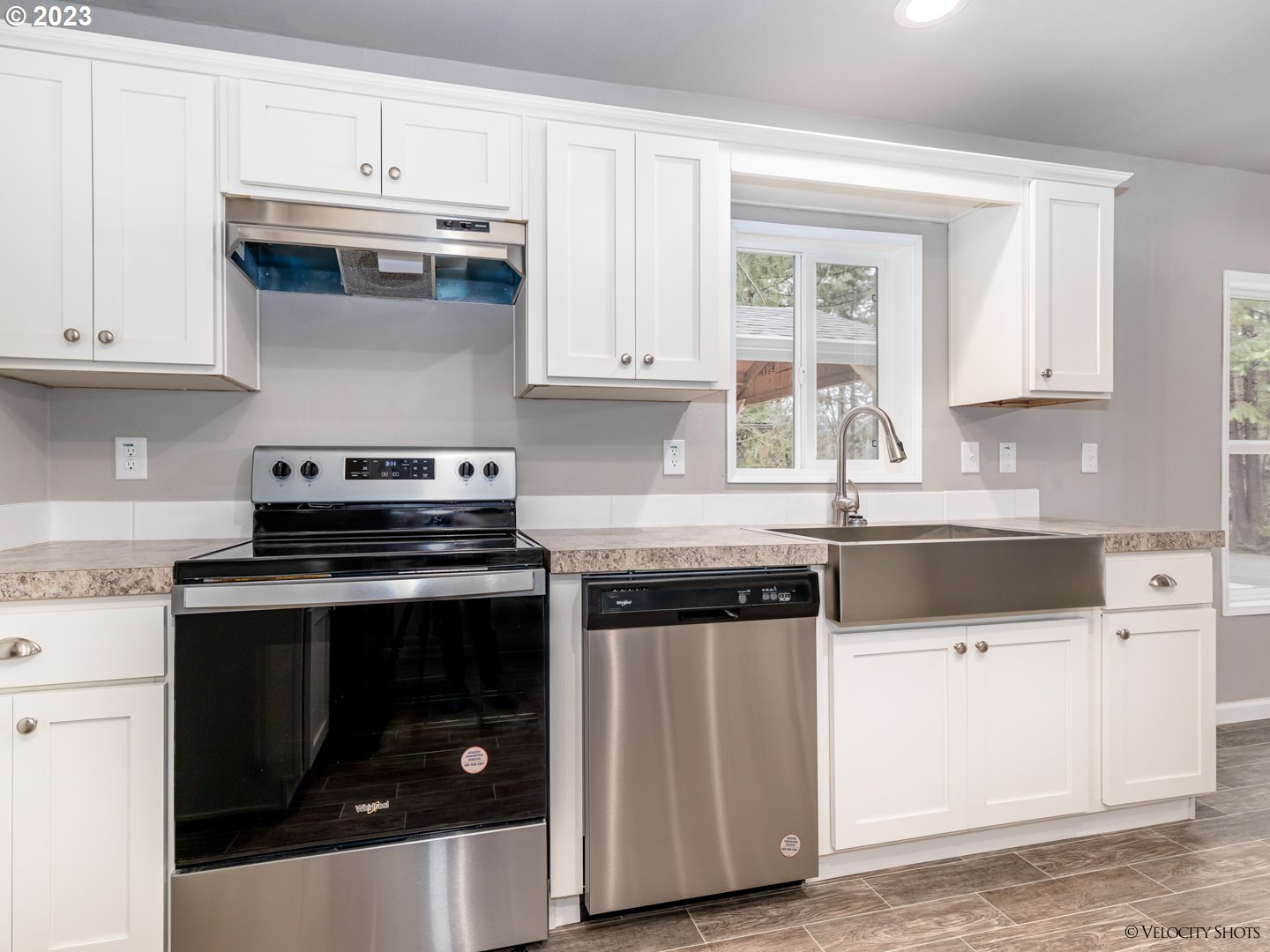 65195 East Sandy River Lane Rhododendron, OR 97049 - Photo 16 of 29 a kitchen with stainless steel appliances granite countertop white cabinets and a stove a oven with white countertops