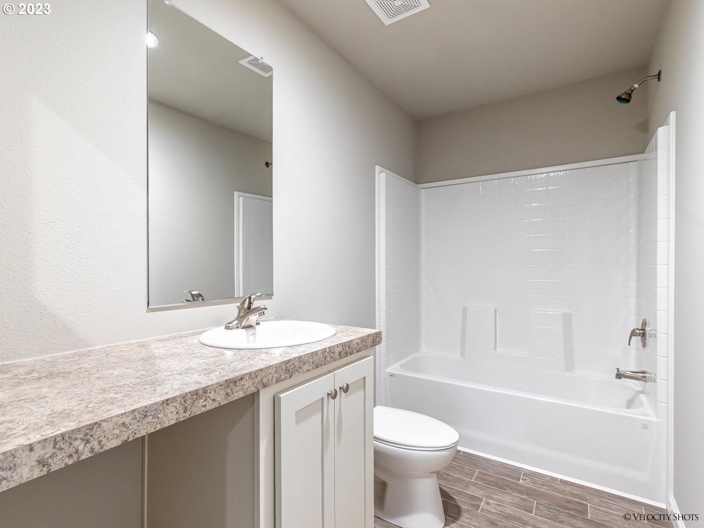 65195 East Sandy River Lane Rhododendron, OR 97049 - Photo 27 of 29 a bathroom with a granite countertop sink a toilet a mirror and bathtub