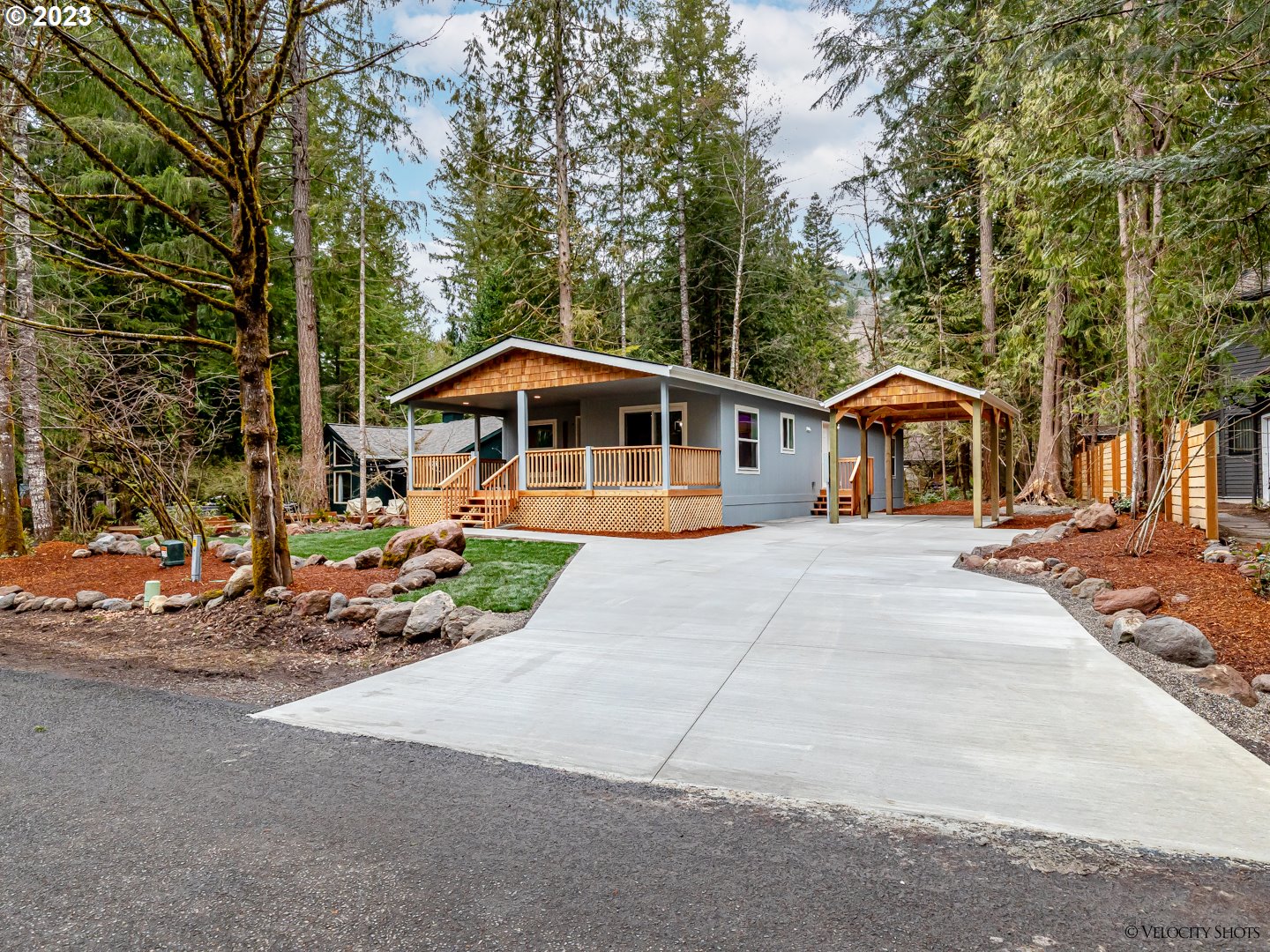 65195 East Sandy River Lane Rhododendron, OR 97049 - Photo 3 of 29 a front view of a house with a yard and trees