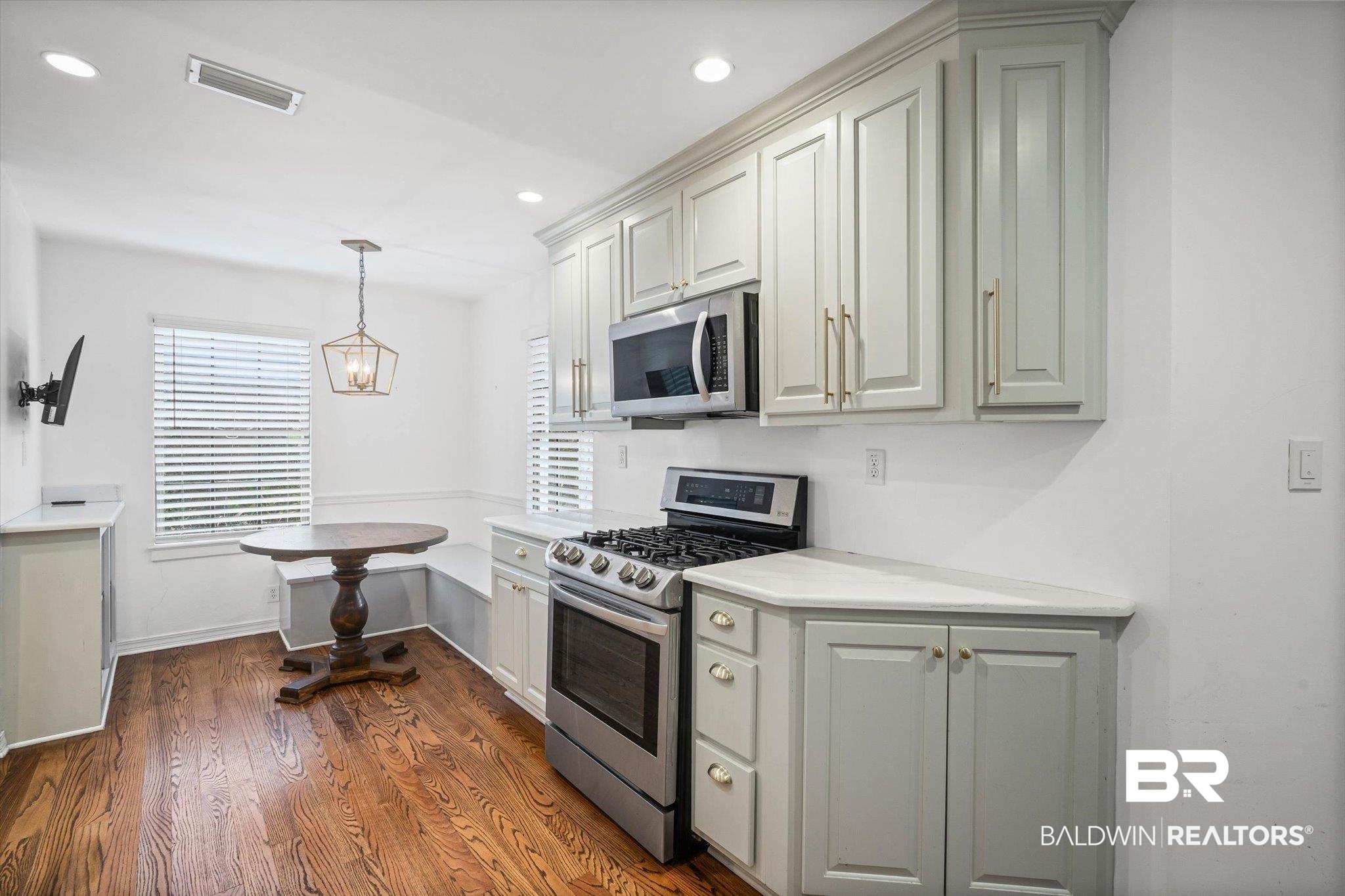 11 York Place Mobile, AL 36608 - Photo 8 of 24 Kitchen featuring appliances with stainless steel finishes, decorative light fixtures, dark wood-type flooring, recessed lighting, and a chandelier
