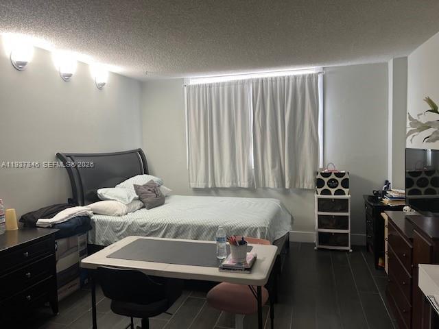 14165 Southwest 87th Street, Unit D202 Miami, FL 33183 - Photo 12 of 23 a bedroom with a bed and a chandelier