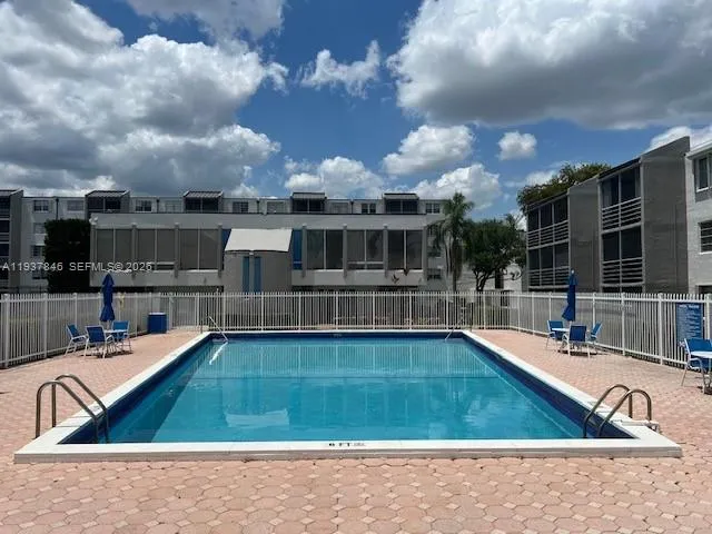 a view of a swimming pool with an outdoor seating
