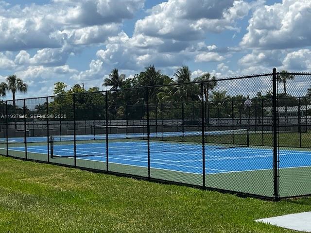 14165 Southwest 87th Street, Unit D202 Miami, FL 33183 - Photo 17 of 23 a view of a garden with iron fence