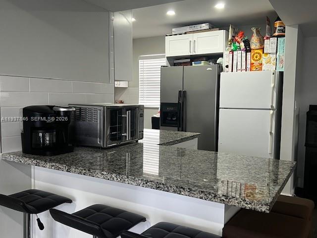 14165 Southwest 87th Street, Unit D202 Miami, FL 33183 - Photo 2 of 23 a kitchen with stainless steel appliances granite countertop a refrigerator and a stove
