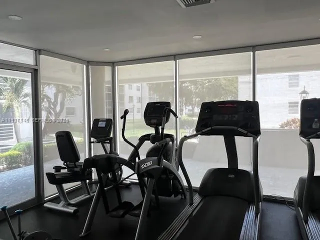 a living room with furniture and large windows