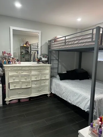 a room with a bed and a mirror