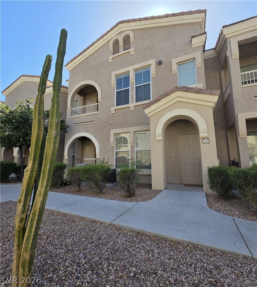 10550 West Alexander Road, Unit 2183 Las Vegas, NV 89129 - Photo 1 of 22 The striking stucco facade of this modern dwelling is enhanced by decorative arches and a gravel landscape.
