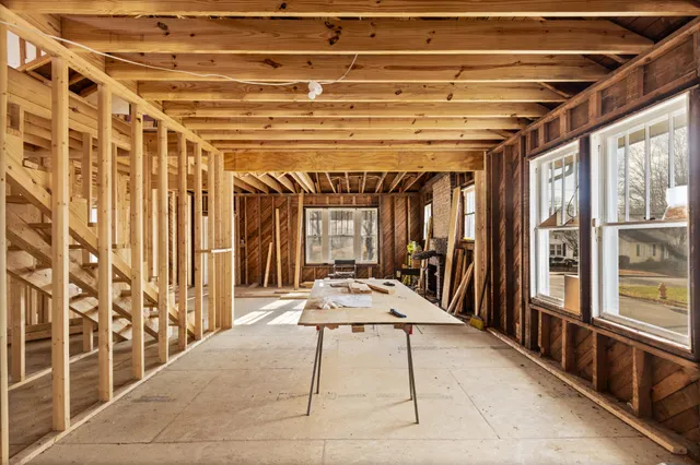a view of a porch with a table and chairs