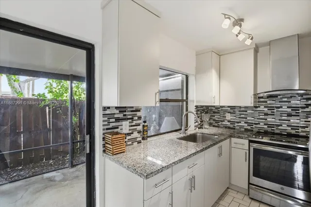 a view of a garden with plants and a table