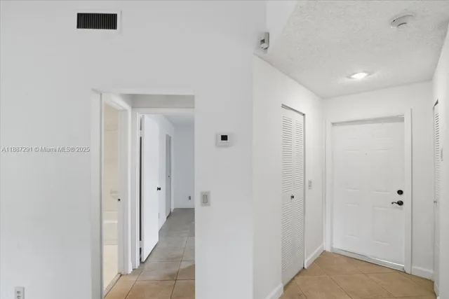 an empty room with floor to ceiling windows