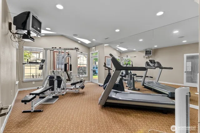 a view of a patio with table and chairs with wooden floor and fence