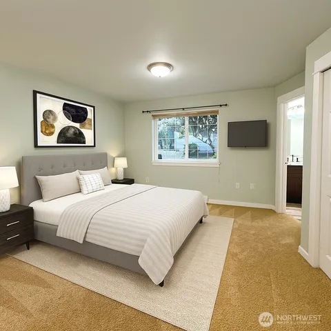 a bedroom with a bed and a painting on the wall