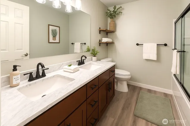 a bathroom with a sink double vanity and a toilet
