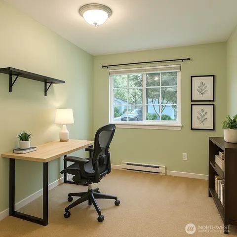 a view of a workspace with furniture and a window