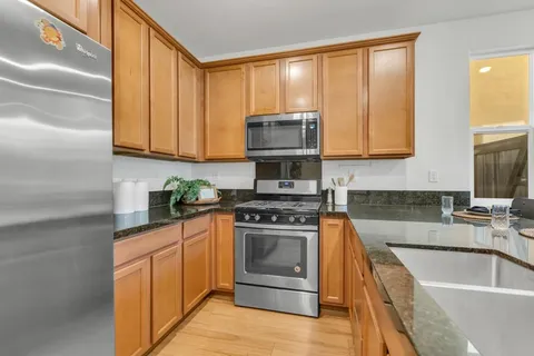 a kitchen with stainless steel appliances granite countertop a stove and a sink
