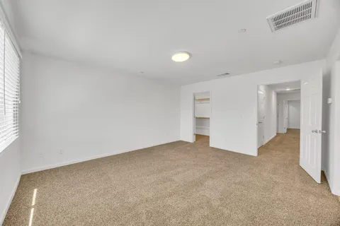 an empty room with windows and closet