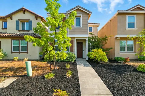 a front view of a house with a garden