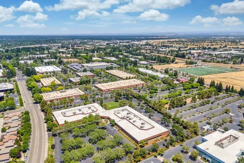 an aerial view of a house with a yard and outdoor seating