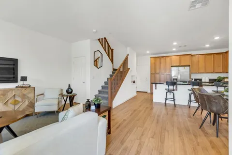 a living room with furniture and a wooden floor