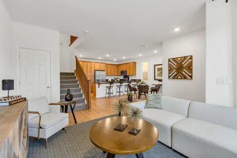 a living room with furniture and wooden floor