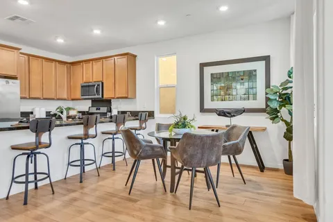 a view of a dining room with furniture window and wooden floor