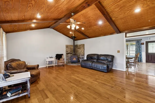 a living room with furniture a dining table and a fireplace
