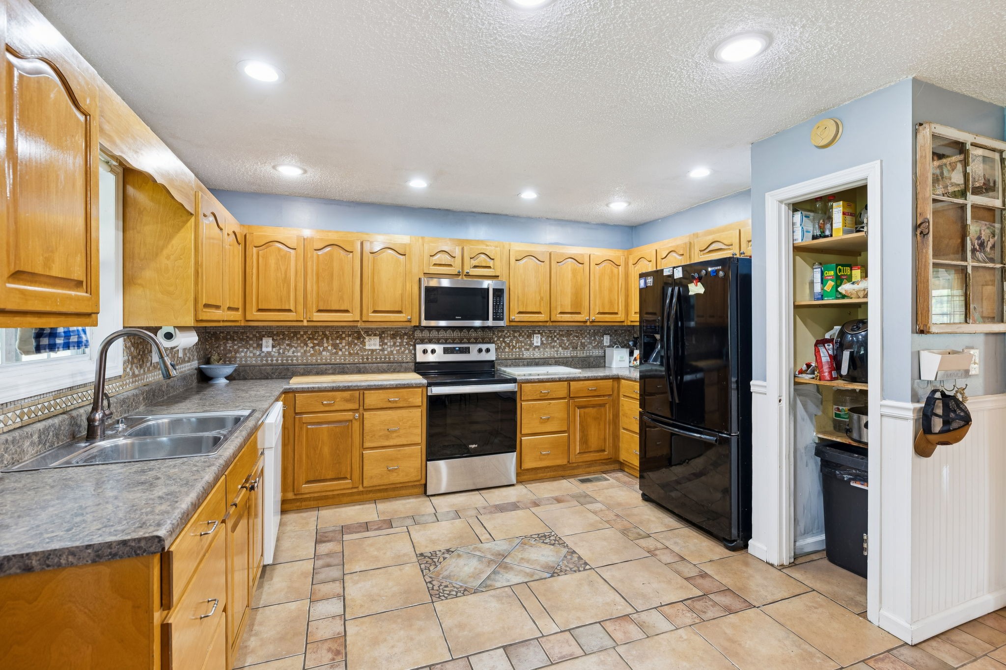 284 Duck Branch Road Fayetteville, TN 37334 - Photo 12 of 47 a kitchen with stainless steel appliances granite countertop a refrigerator and a sink