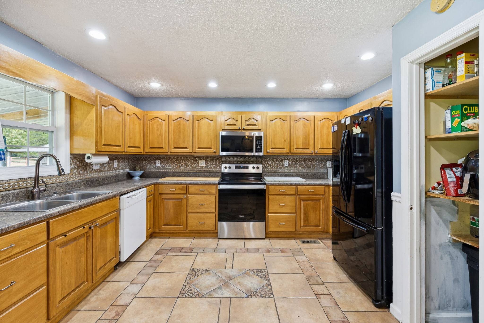 284 Duck Branch Road Fayetteville, TN 37334 - Photo 13 of 47 a kitchen with stainless steel appliances granite countertop a refrigerator and a stove top oven