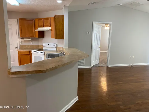 a kitchen with stainless steel appliances granite countertop a sink and a stove top oven