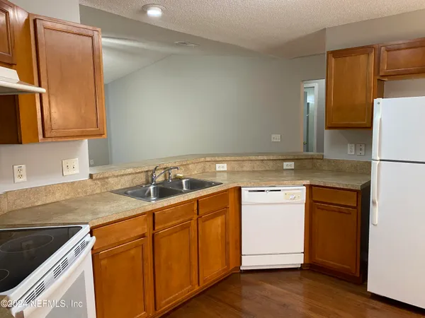 a kitchen with a sink cabinets and stainless steel appliances