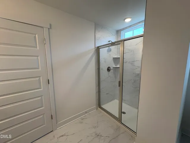 a view of an empty room with windows and closet