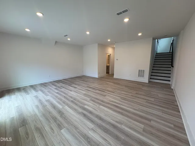 a bathroom with a granite countertop sink mirror and toilet