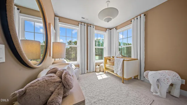 a bedroom with bed and a large window