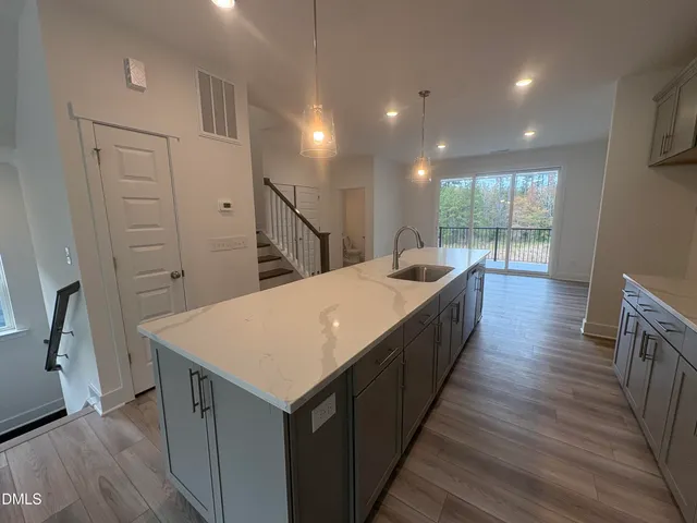 a kitchen with sink and refrigerator