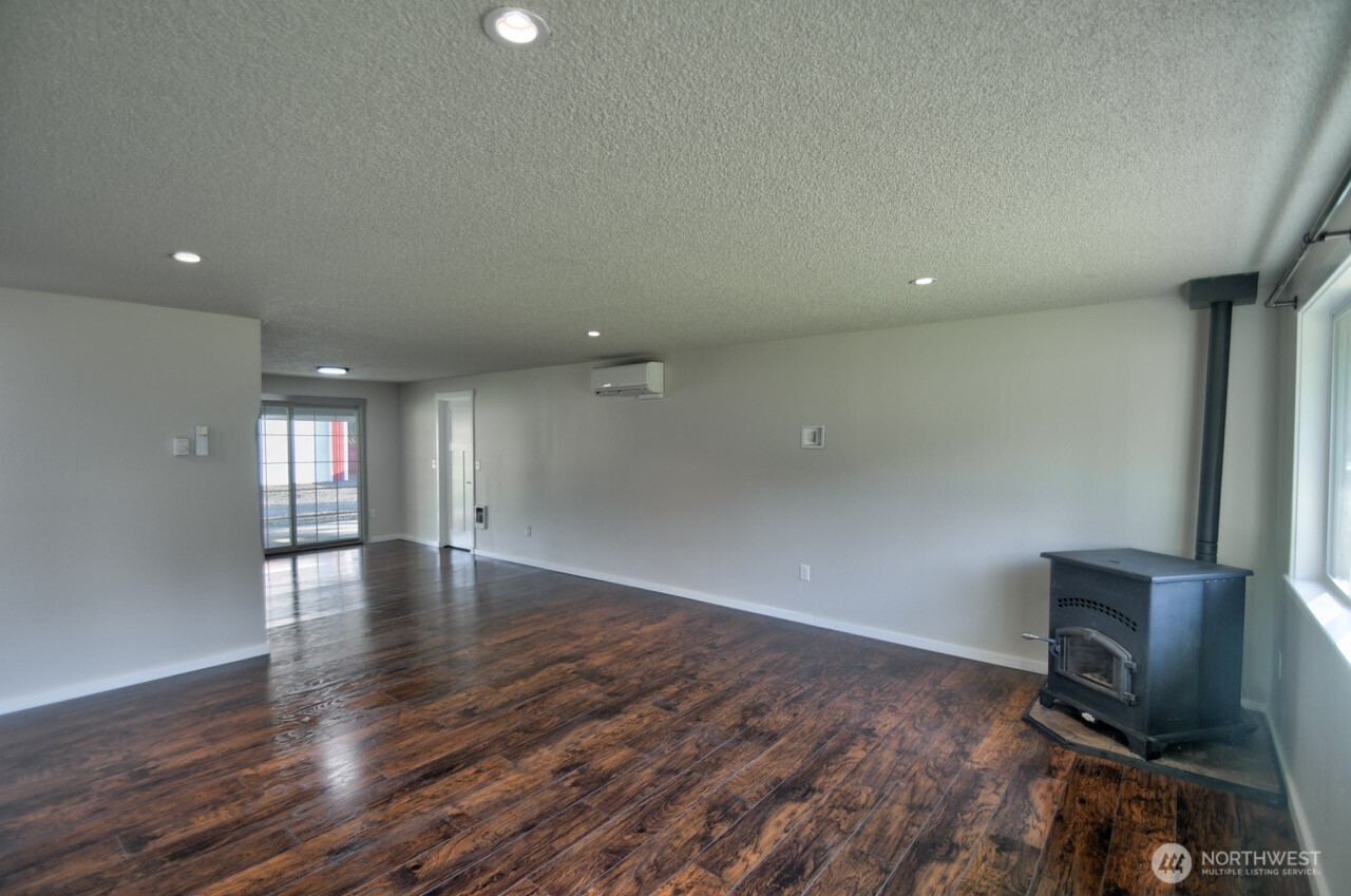 19140 Rosemary Street Southwest Rochester, WA 98579 - Photo 11 of 26 a view of an empty room with wooden floor and a window