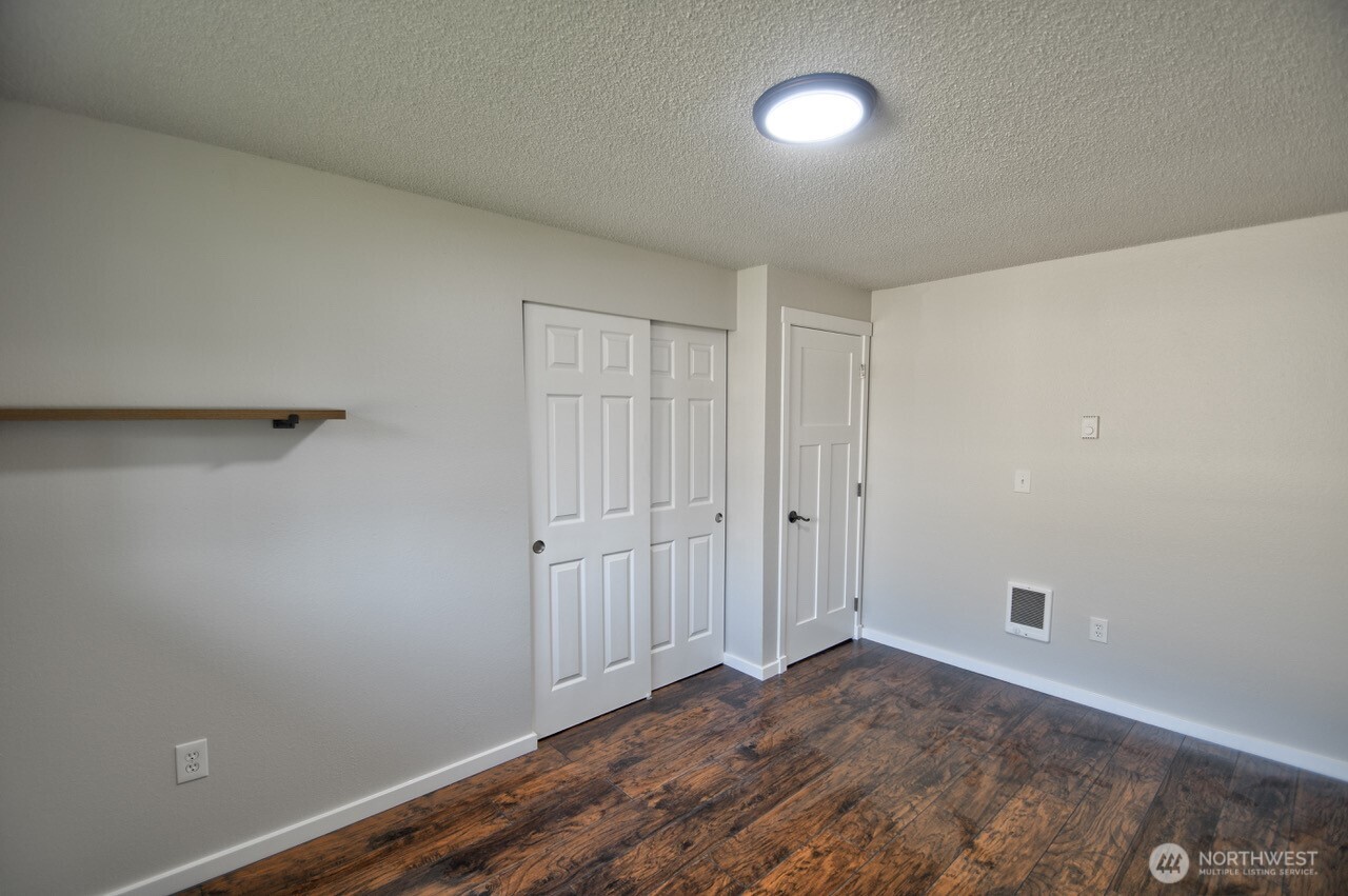 19140 Rosemary Street Southwest Rochester, WA 98579 - Photo 15 of 26 a view of an empty room and wooden floor