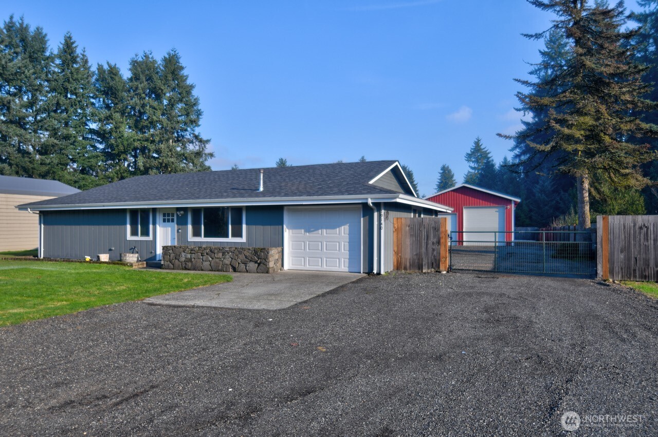 19140 Rosemary Street Southwest Rochester, WA 98579 - Photo 2 of 26 a front view of a house with a yard and garage