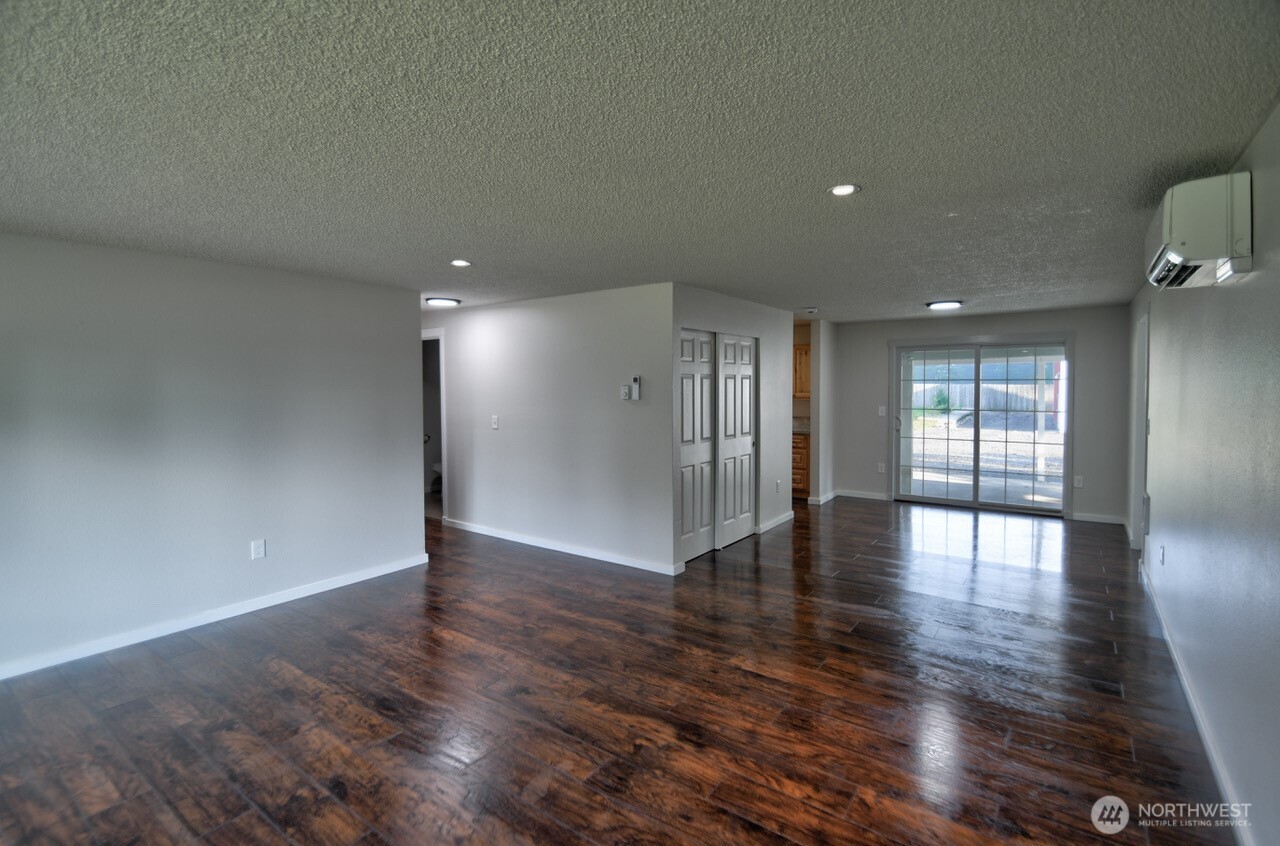 19140 Rosemary Street Southwest Rochester, WA 98579 - Photo 7 of 26 a view of an empty room with wooden floor and a window