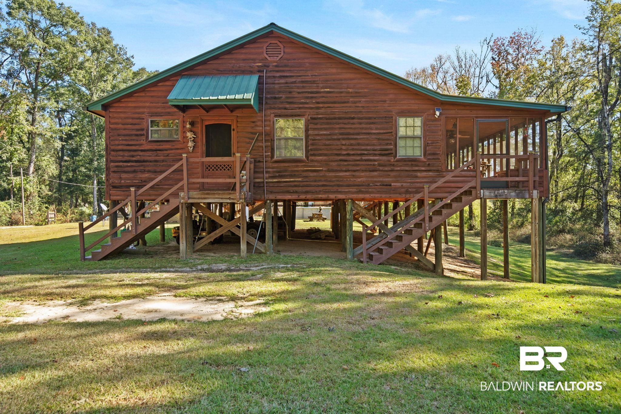 724 Rowell Lane Brewton, AL 36426 - Photo 8 of 40 Rear view of house with a lawn, stairway, and a metal roof
