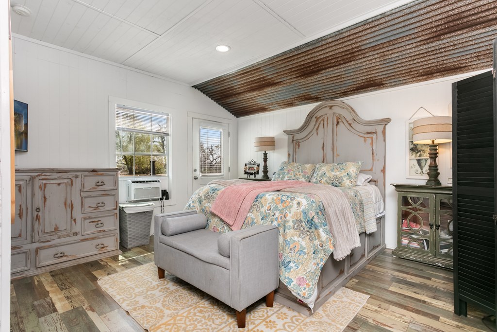 3527 Old Harper Road Fredericksburg, TX 78624 - Photo 15 of 43 a spacious bedroom with a bed a couch and dresser