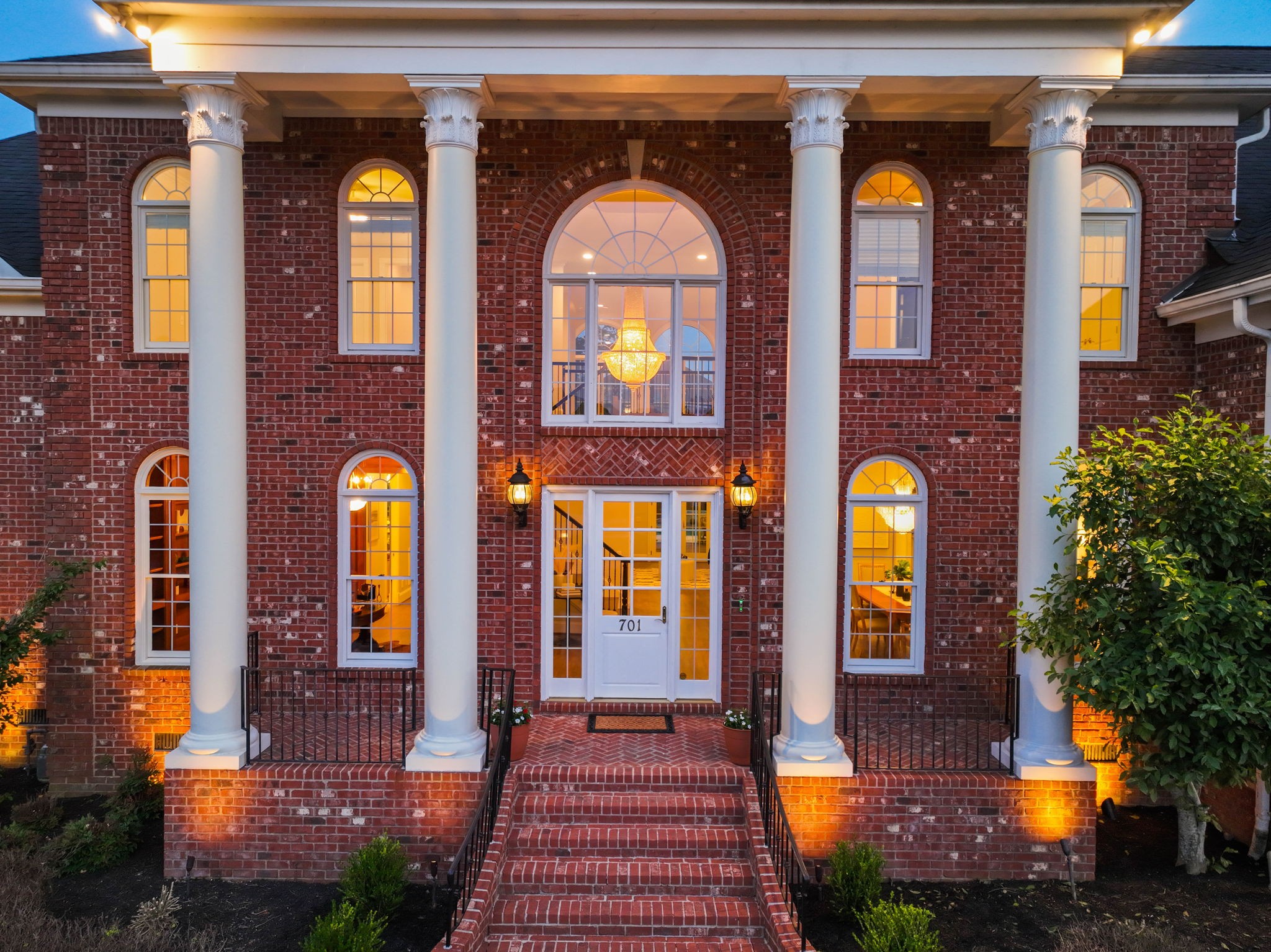 701 Sinclair Circle Brentwood, TN 37027 - Photo 63 of 70 a front view of a house with large windows and a yard