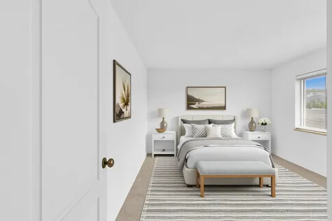 a bedroom with a bed and a painting on the wall